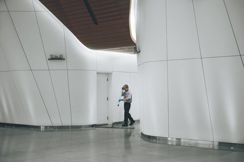 man cleaning floor of company building